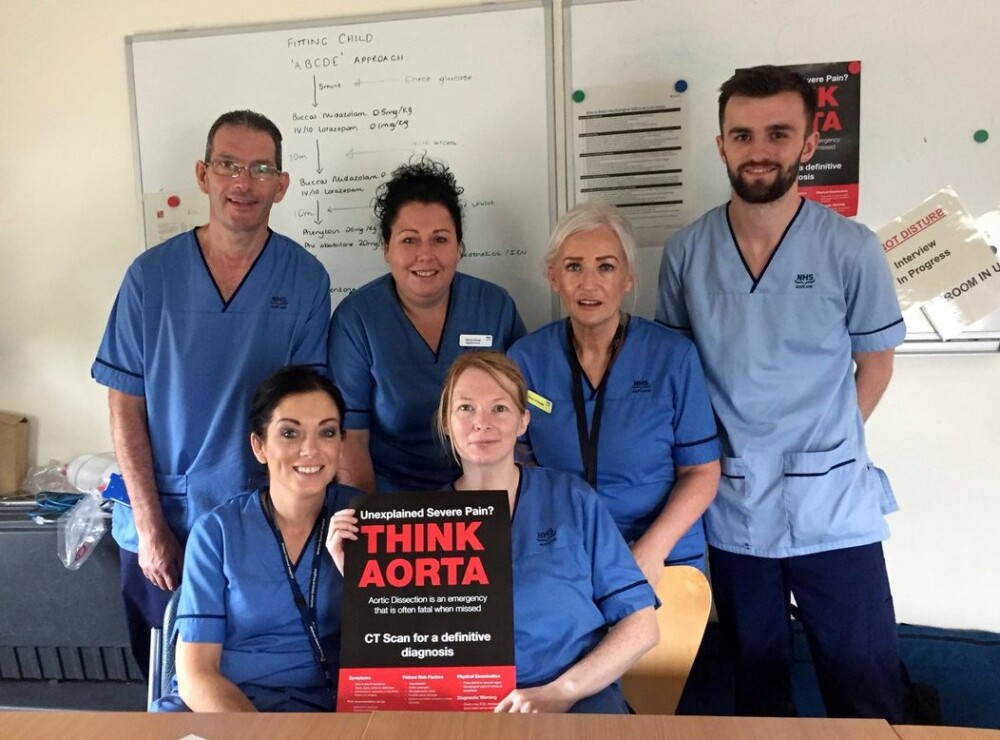 A photo of the Emergency Department team at Wishaw General Hospital in Lanarkshire holding a THINK AORTA poster